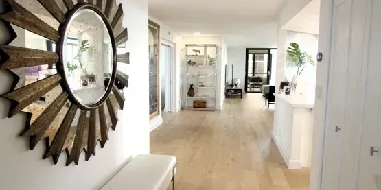Modern hallway with round mirror and decor.