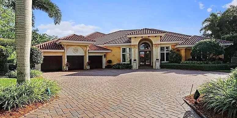 Elegant house with tiled roof and driveway.