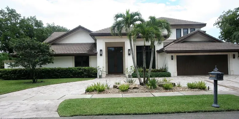 Modern suburban house with palm trees.