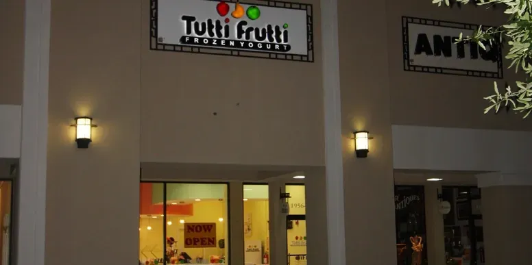 Frozen yogurt shop exterior at night.