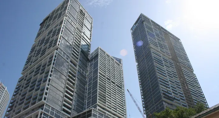 Tall modern skyscrapers under clear blue sky.