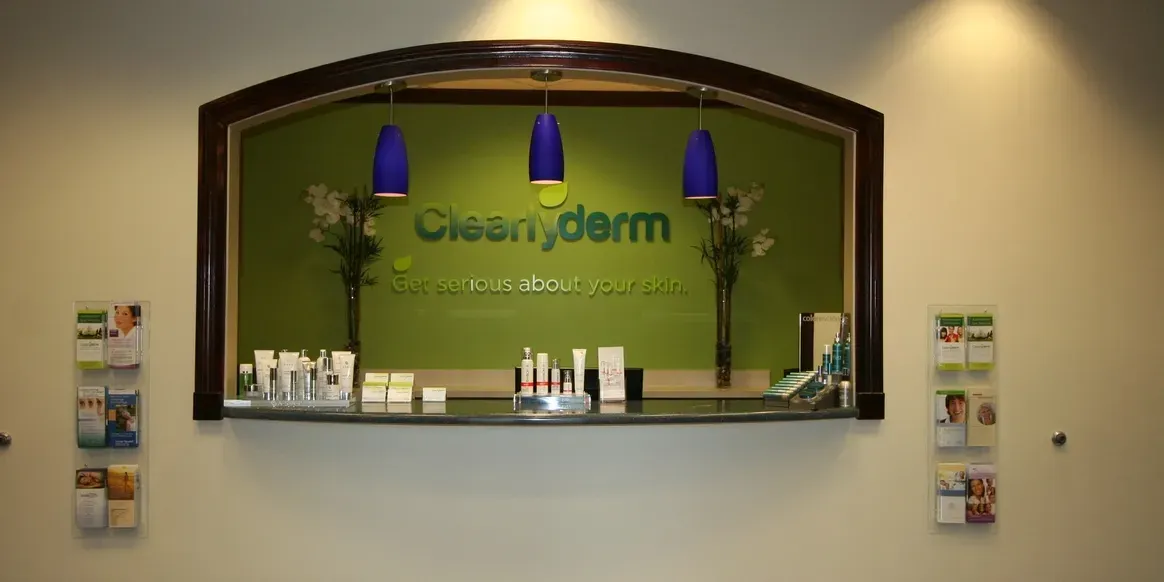 Skincare clinic reception with product display.