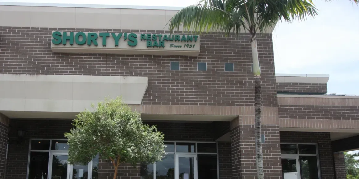 Shorty's Restaurant exterior with palm tree.
