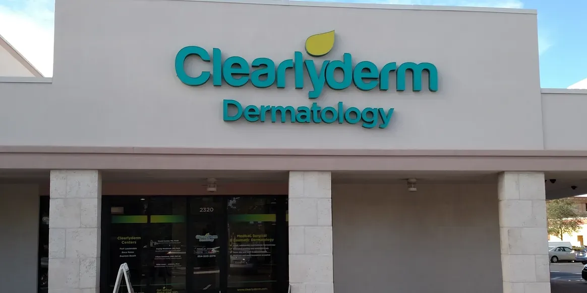 Dermatology clinic exterior with logo signage.