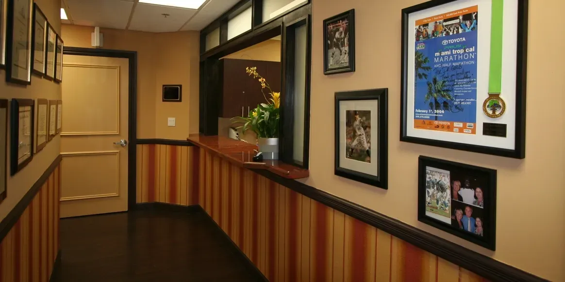 Hallway with framed pictures and awards displayed.