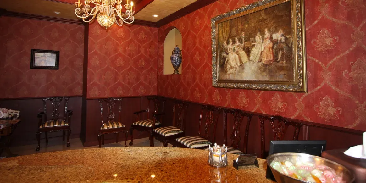 Elegant room with ornate decor and painting.