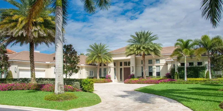 Luxurious house with palm trees and garden.